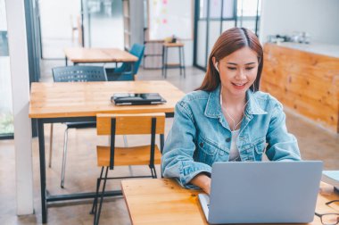 young student wearing small talk studies online, distance learning, and keeps up to date on the global coronavirus pandemic