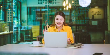 young student wearing headphones studies online, distance learning, and keeps up to date on the global coronavirus pandemic.