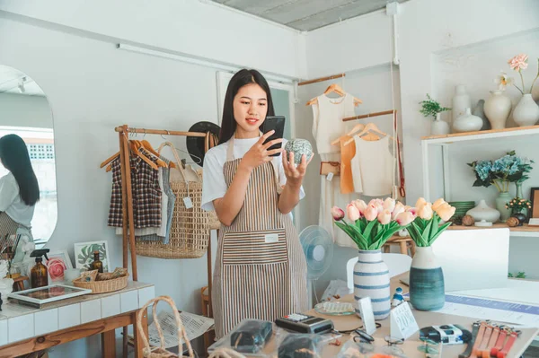 Small business owners are taking pictures of products to send to customers who will shop and take orders that customers order from an online retailer - online shopping.