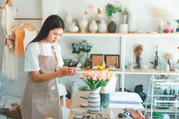 Small business owners are taking pictures of products to send to customers who will shop and take orders that customers order from an online retailer - online shopping.