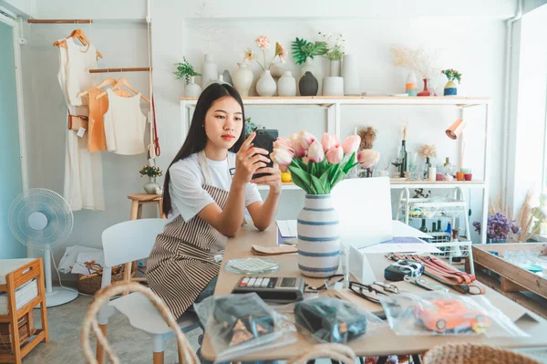 Small business owners are taking pictures of products to send to customers who will shop and take orders that customers order from an online retailer - online shopping.