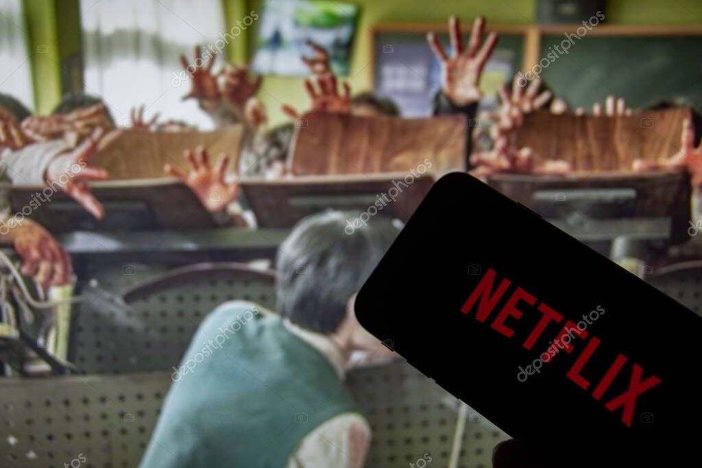 Rheinbach, Germany  2 February 2022,  The Netflix logo on the display of a smartphone in front of a television with the new series 