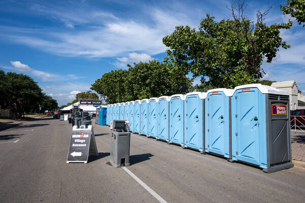 Waco, Texas - Oct. 21, 2021: Porta potties and wash stations are set up at the IRONMAN Village for the inaugural Ironman Waco event October 23 and 24.