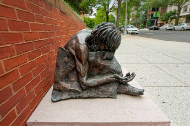 Washington, DC, USA - June 26, 2022: This statue depicting homeless Jesus by sculptor Timothy Schmalz is outside the Cathedral of St. Matthew the Apostle.