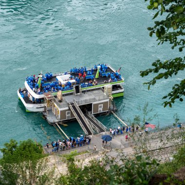 Niagara Falls, NY - July 31, 2022: Passengers boarding the Maid of The Mist tour boat are provided with blue ponchos since the boat travels close enough to Horseshoe Falls to get wet.