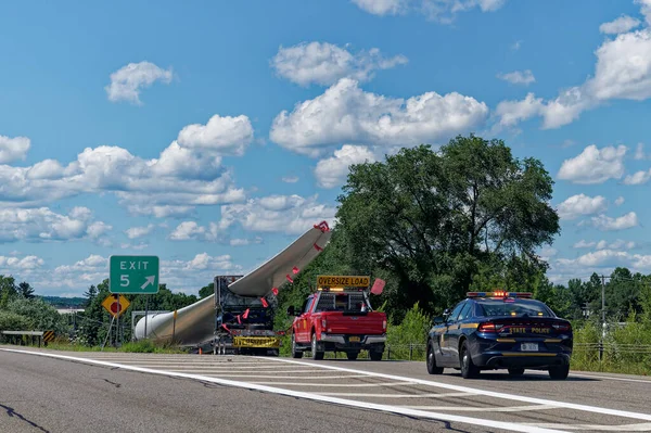 Dansville, New York - July 29, 2022: Oversize Load exiting I-390 with a windmill rotor blade