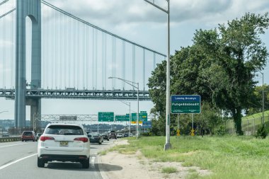 Brooklyn, New York - 22 Ağustos 2018: Belt Parkway 'de Brooklyn Fuhgeddaboudit' ten ayrılacağınız yazan Verrazano-Narrows Köprüsü 'ne yaklaşırken yol işareti.