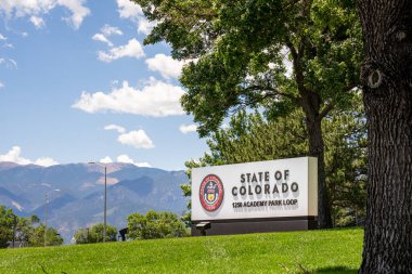 Colorado Springs, CO - July 8, 2022: State of Colorado sign with state seal on the corner of S. Academy and E. Fountain Blvds. clipart