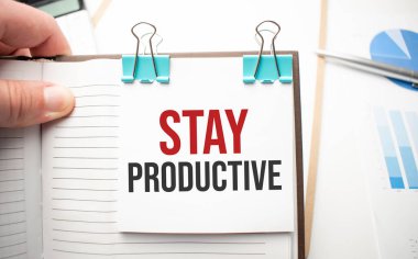 Beyaz gelecekteki hesap makinesi, kağıt çarşaf, pembe ataç ve gümüş renkli kalem. Metin Üretken Kal