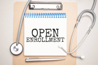 Üzerinde açık kayıt ve mavi arka planda steteskop yazan beyaz bir not defteri. Tıbbi konsept