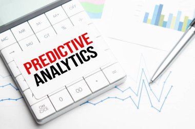Text PREDICTIVE ANALYTICS Calculator, pen and charts, documents and graphs. Business and tax concept on white background. Top view. clipart