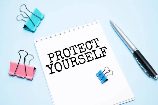 Белый Блокнот Текстом Protect Yourself Офисные Инструменты Синем Фоне — стоковое фото