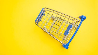 Sarı arka plandaki alışveriş arabasında fotokopi alanı var.