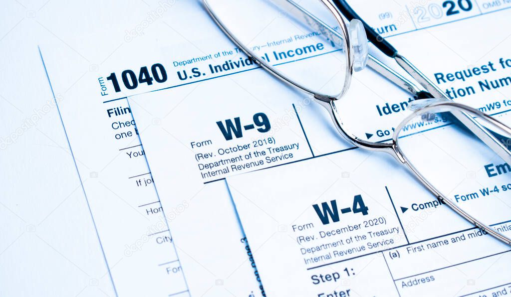 Financial Image Of Some Tax Forms With Glasses And A Pen