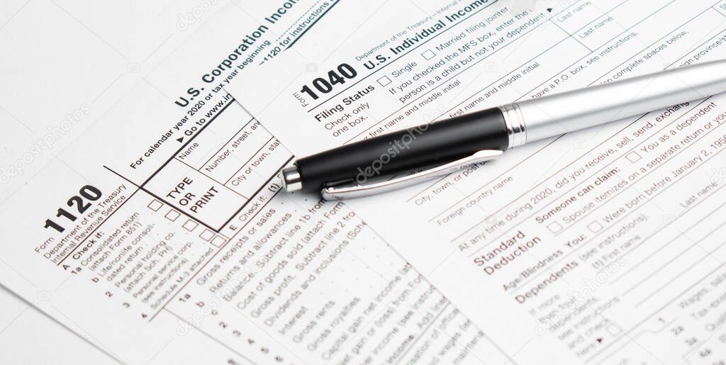 Pen on US TAX form Background. Tax Day concept