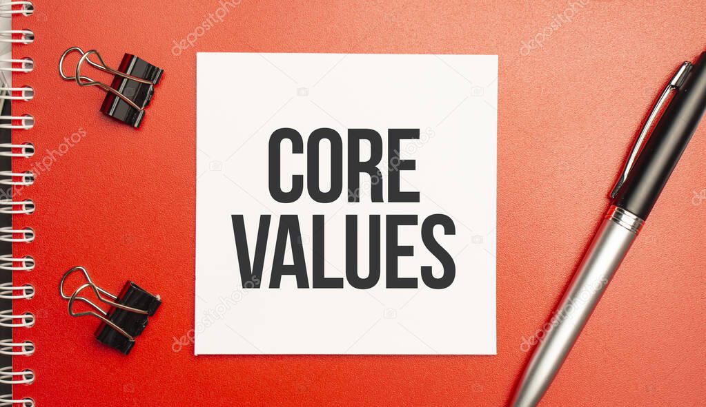 Core Values sign on sheet of paper on the red notepad with pen