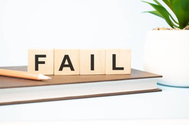 fail word written on wooden cubes with copy space