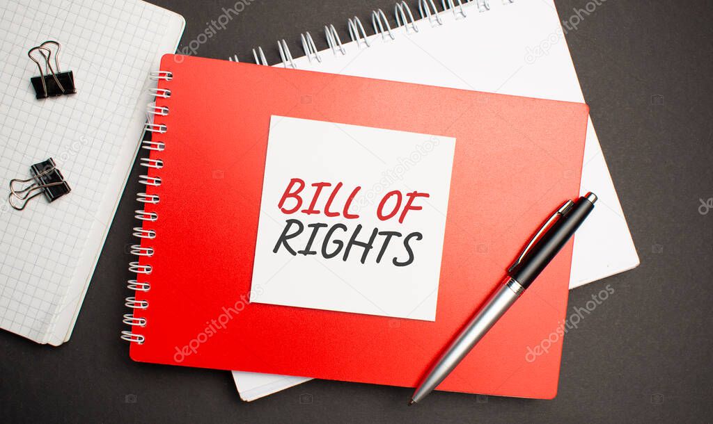 BILL OF RIGHTS sign on sheet of paper on the red notepad with pen