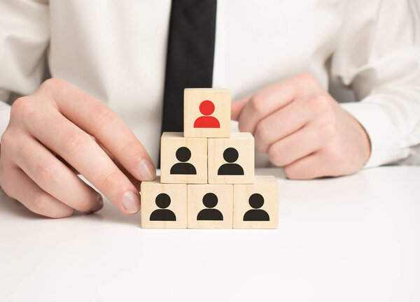 Human Resource Management and Recruitment Business Concept, Hand Putting Wooden Cube Block on Top Pyramid, Copy Space