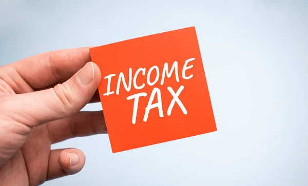 Income Tax Słowo Papierze Rękach Biznesmena — Zdjęcie stockowe