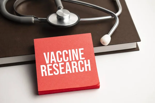 Papier Tekstem Vaccine Research Niebieskim Tle Stetoskop Pigułki — Zdjęcie stockowe