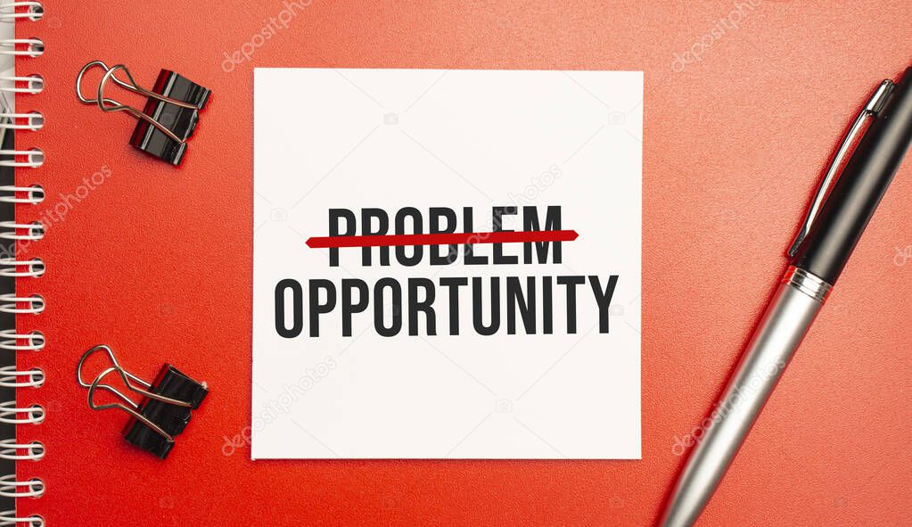 Problem Opportunity sign on sheet of paper on the red notepad with pen