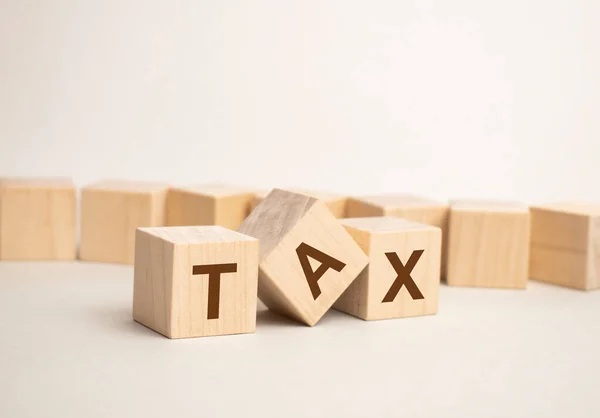 Three Wooden Cubes Letters Tax Bright Surface Gray Table Inscription — Stock Photo, Image