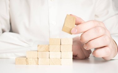 Tahta blokları merdiven şeklinde istiflemek için. İş geliştirme, strateji kavramı. Başarı temeli oluşturuluyor