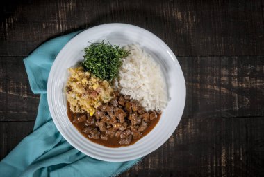 Tipik Brezilya yemeği, doğranmış et, pirinç, karalahana ve yumurta kırıntıları.