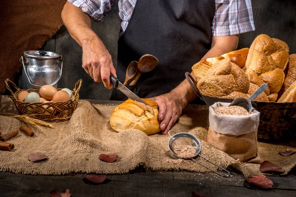 Baker Cutting Bread Rustic Table — Stock Photo, Image