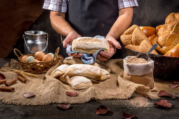 Baker Holds Breads Rustic Table — Stock Photo, Image