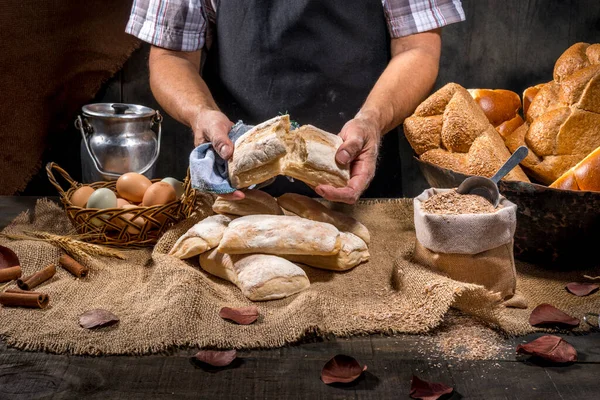 Baker Holds Breads Rustic Table — Stock Photo, Image