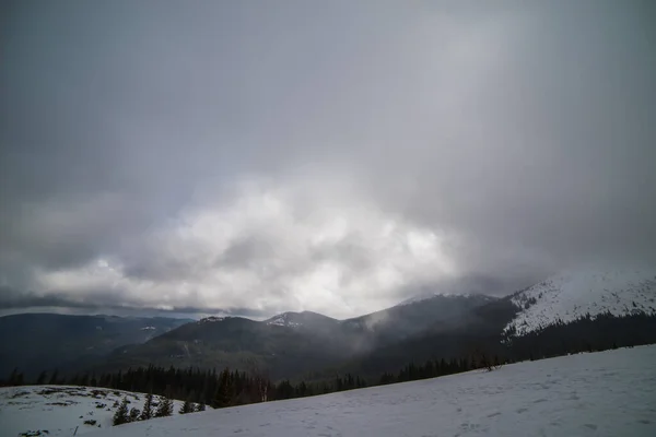 暗い冬の空の下で雪と冬の山 — ストック写真