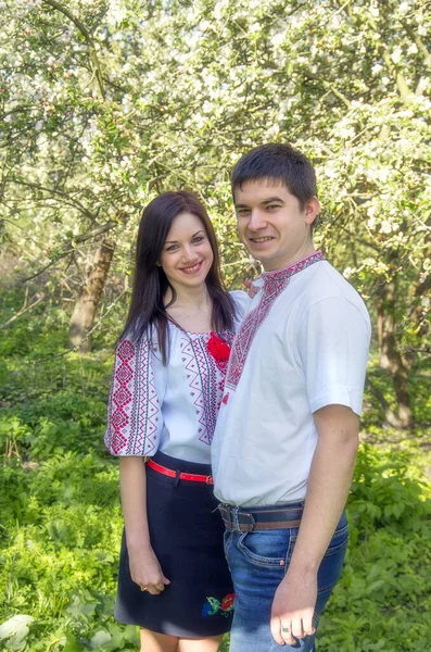 Young Loving Couple Man Woman White Embroidered Shirts Flowering Tree — ストック写真