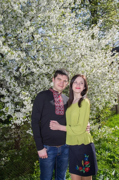 Young Loving Couple Man Woman Embroidered Shirts Flowering Tree Spring — ストック写真