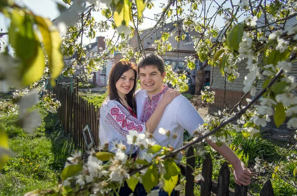 Young Loving Couple Man Woman White Embroidered Shirts Flowering Tree — ストック写真