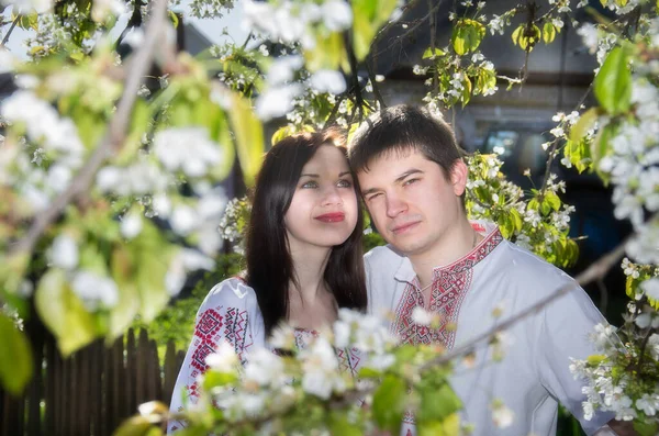 Young Loving Couple Man Woman White Embroidered Shirts Flowering Tree — ストック写真