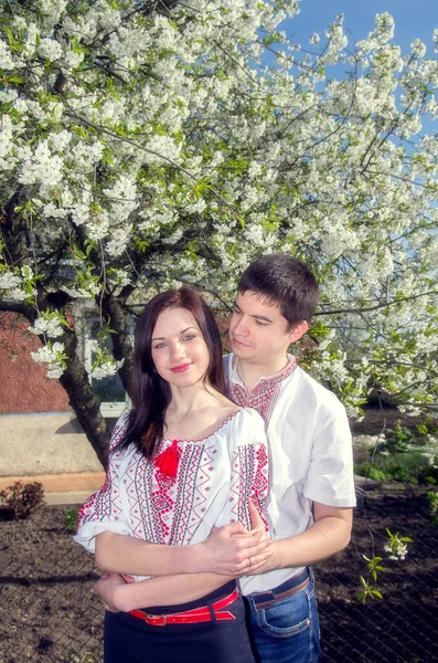 Young Loving Couple Man Woman White Embroidered Shirts Flowering Tree — 스톡 사진