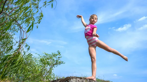 Dívka Dělá Vlaštovku Gymnastickou Postavu Proti Obloze — Stock fotografie