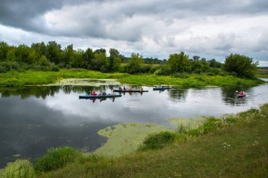 Lutsk. Ukraine. August 1, 2022 A group of tourists are kayaking along a beautiful river.