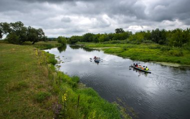 Kayaks with tourists on a clean, untouched by civilization river of Volyn Polissya.