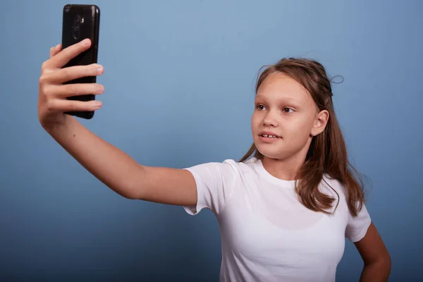 Beautiful Girl Years Old Takes Selfie Blue Background — Stock Photo, Image