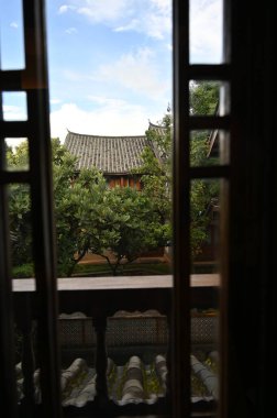Exploring the ancient town of Lijiang in Yunnan province of China and admiring the ornate and interesting wooden buildings