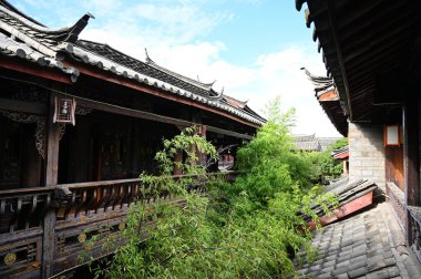Exploring the ancient town of Lijiang in Yunnan province of China and admiring the ornate and interesting wooden buildings