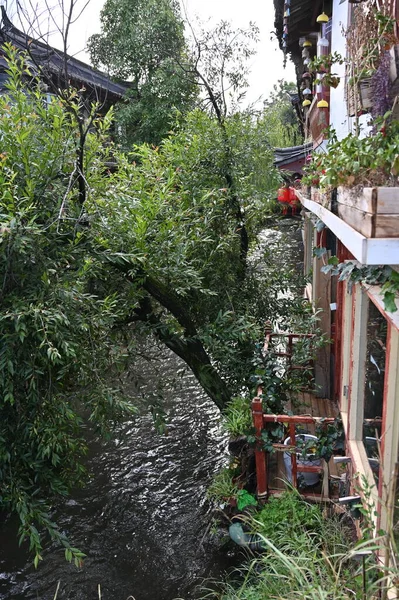 Exploring the ancient town of Lijiang in Yunnan province of China and admiring the ornate and interesting wooden buildings