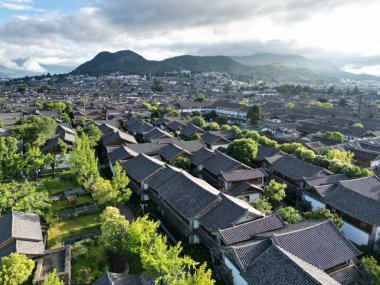 Aerial view of the old town in the city of Lijiang - exploring the soaring skies on a sunny summer day in Yunnan province