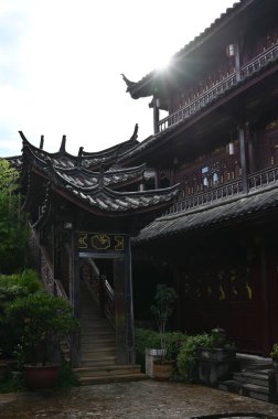 Exploring the ancient town of Lijiang in Yunnan province of China and admiring the ornate and interesting wooden buildings
