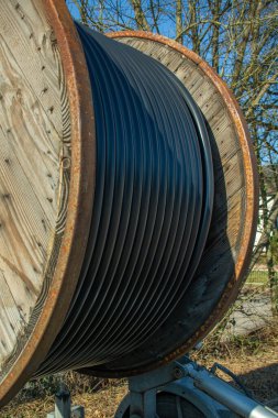 Wooden Cable drum for power cable during road construction in a new development area in Germany