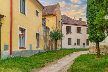 romantic dreamy narrow street in vivid colors. The light flair of decay supports the romantic mood