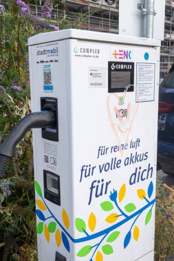 Heidelberg, Germany: August, 12. 2022: Close up of the power supply plugged into an public electric charging station. Power supply for electric car charging.
